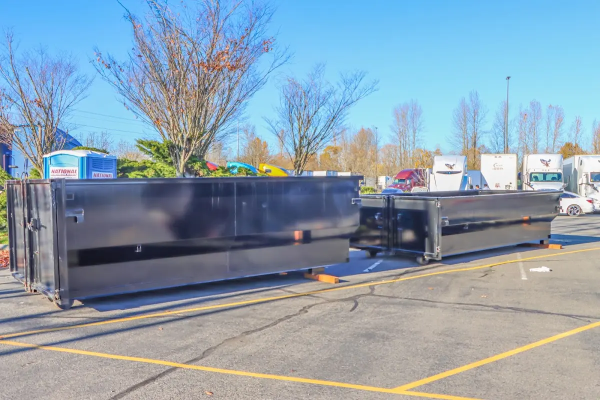 Professional dumpster rental service with roll-off container on residential driveway in Ohio